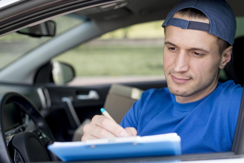 Young man signing paper.