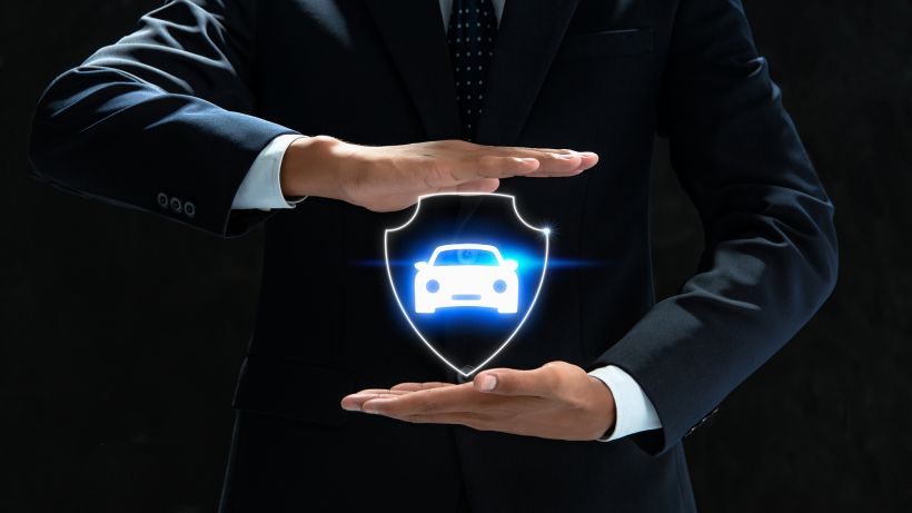 Businessman holding car icon.
