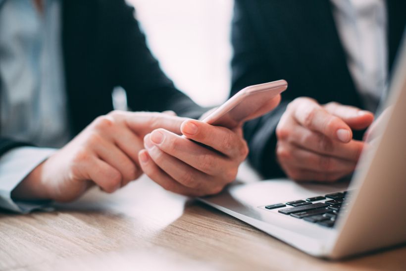Businessman reading a message on his cell phone.
