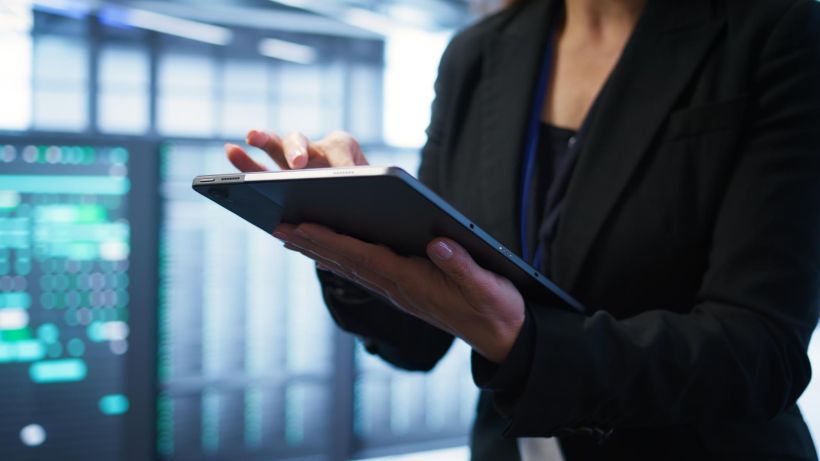 Close up shot of person in server room optimizing data center gear.