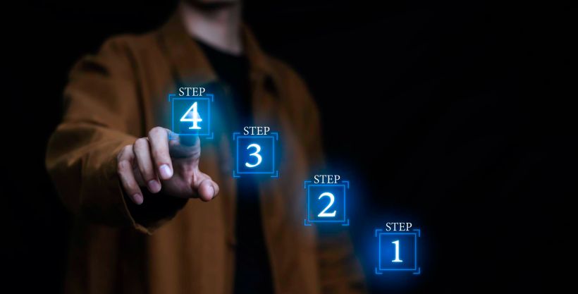 Businessman holds a hologram stacking as step by step ladder business growth personnel progress.