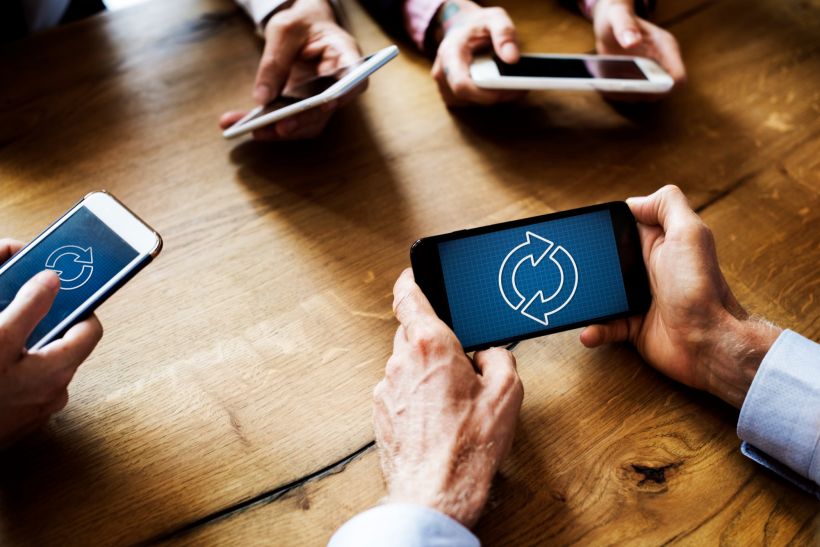 Business people using smart phones.