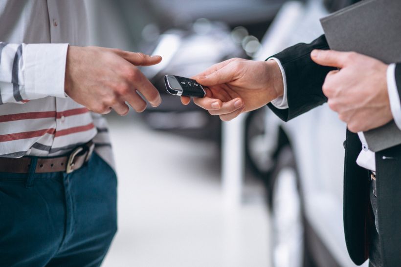 Close-up of a man's hands holding car keys.