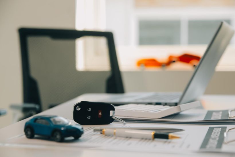 The sales manager offers to sell the car and explains and reads out the terms and conditions of signing the car contract and insurance.