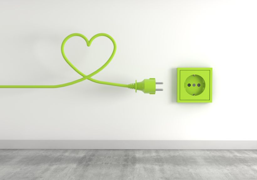 3d render of a green electrical plug isolated on a socket background- eco energy concept.