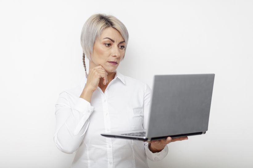 Front view business woman holding laptop and thinking.